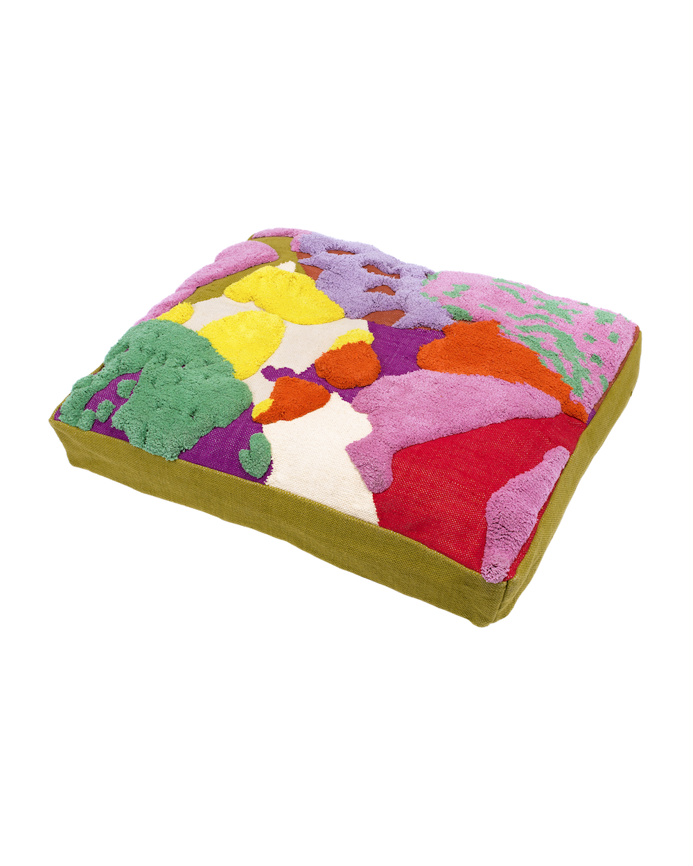 A large, thick, rectangular floor cushion or pet bed with a vibrant, abstract design. The cushion is shown resting on a light-gray background. The top surface features an abstract, highly textured pattern of large, overlapping shapes in a diverse color palette, primarily using a plush, tufted, or loop pile yarn. The colors visible are: Bright yellow Hot pink (magenta) Vivid red Deep purple Lime green Orange Emerald green The sides (gusset) of the thick cushion are made of a sturdy, flat woven fabric in a solid olive-green/chartreuse color. The cushion is slightly angled to show its substantial thickness