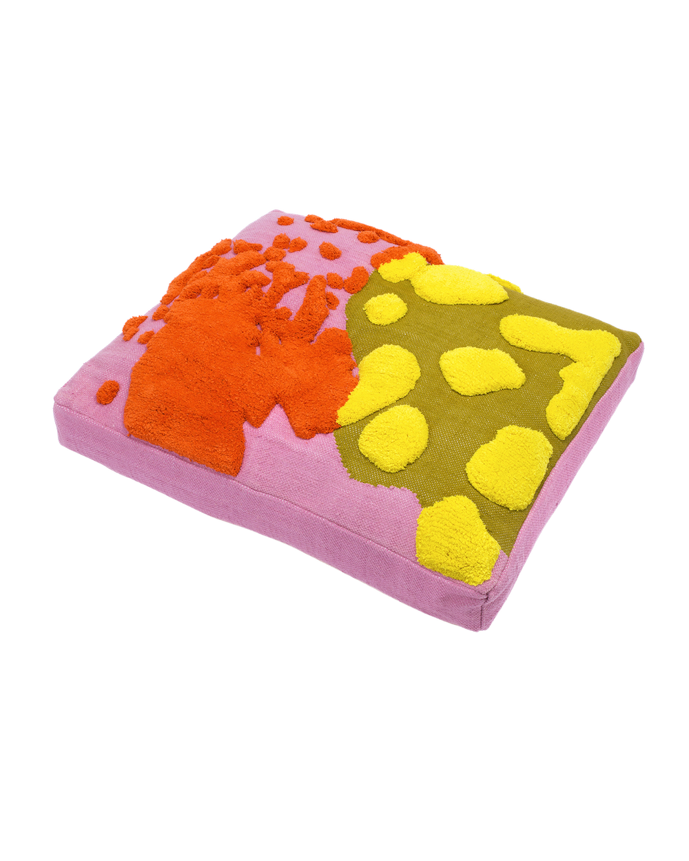 A large, thick, rectangular floor cushion or pet bed with a contrasting two-part abstract design. The cushion is shown resting at an angle against a plain, light-gray background. The top surface is split into two distinct, highly textured sections: Left/Top Section: A base fabric of solid dusty rose pink is partially covered by large, raised, splash-like forms and scattered dots of bright orange tufted yarn. Right/Bottom Section: This section features a solid olive-green base fabric covered in large, irregular, polka-dot-like shapes of bright yellow tufted yarn. The sides (gusset) of the thick cushion are made of a sturdy, flat woven fabric that appears to match the dusty rose pink color of the left-hand section. The cushion is angled to show its substantial, squared thickness.