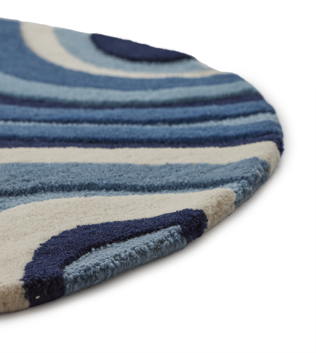 zoomed in photo of a small 3' round area rug with multiple shades of blue