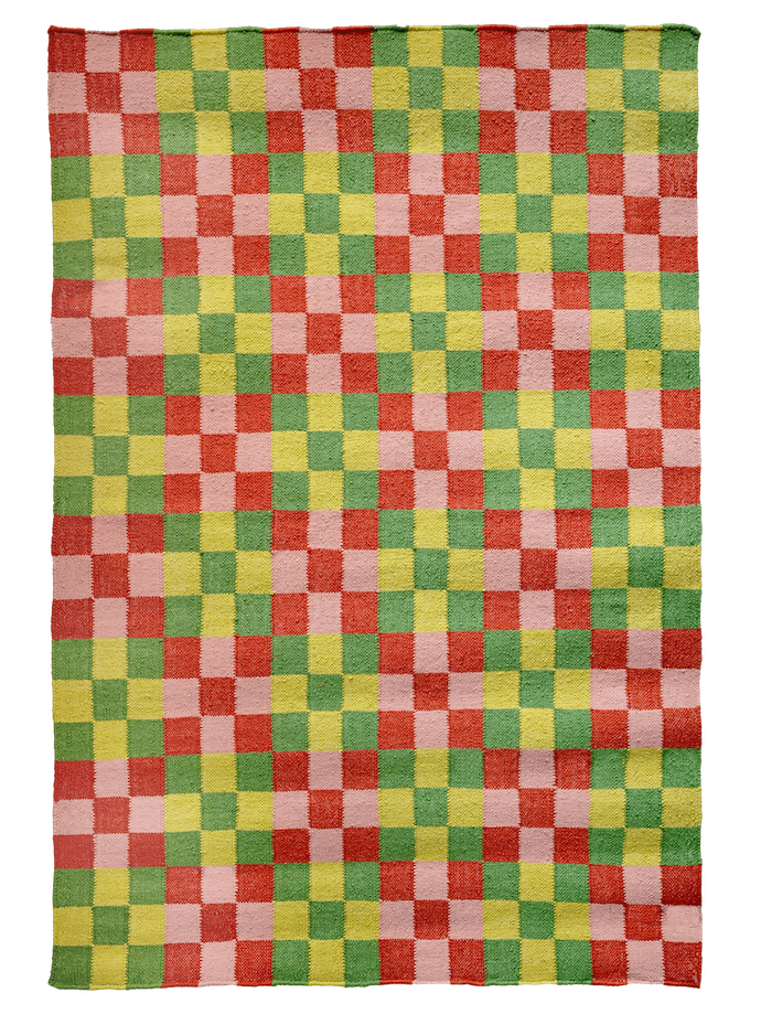 A rectangular rug features a checkerboard pattern composed of squares in vibrant shades of red, pink, yellow, and green. The colors are evenly distributed, creating a lively and colorful mosaic.