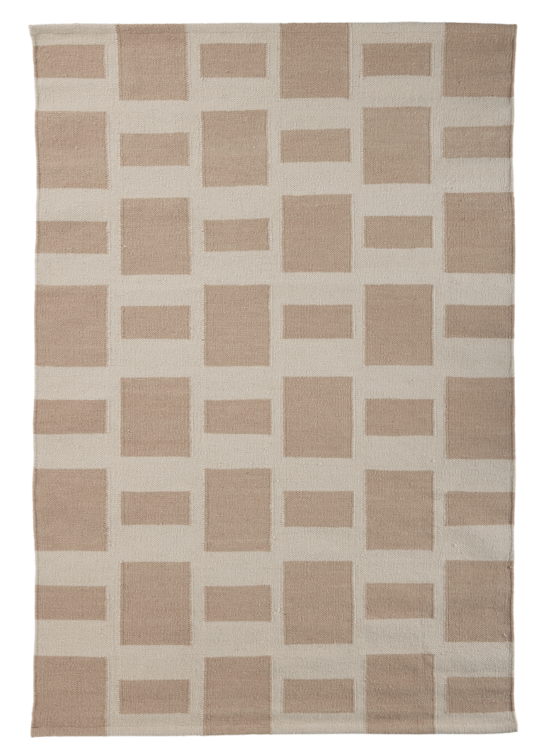 A rectangular flat-weave rug by angela adams featuring a rhythmic grid of alternating sand-colored and cream rectangles. The pattern consists of large vertical blocks and smaller horizontal blocks in a staggered, neutral-toned layout.