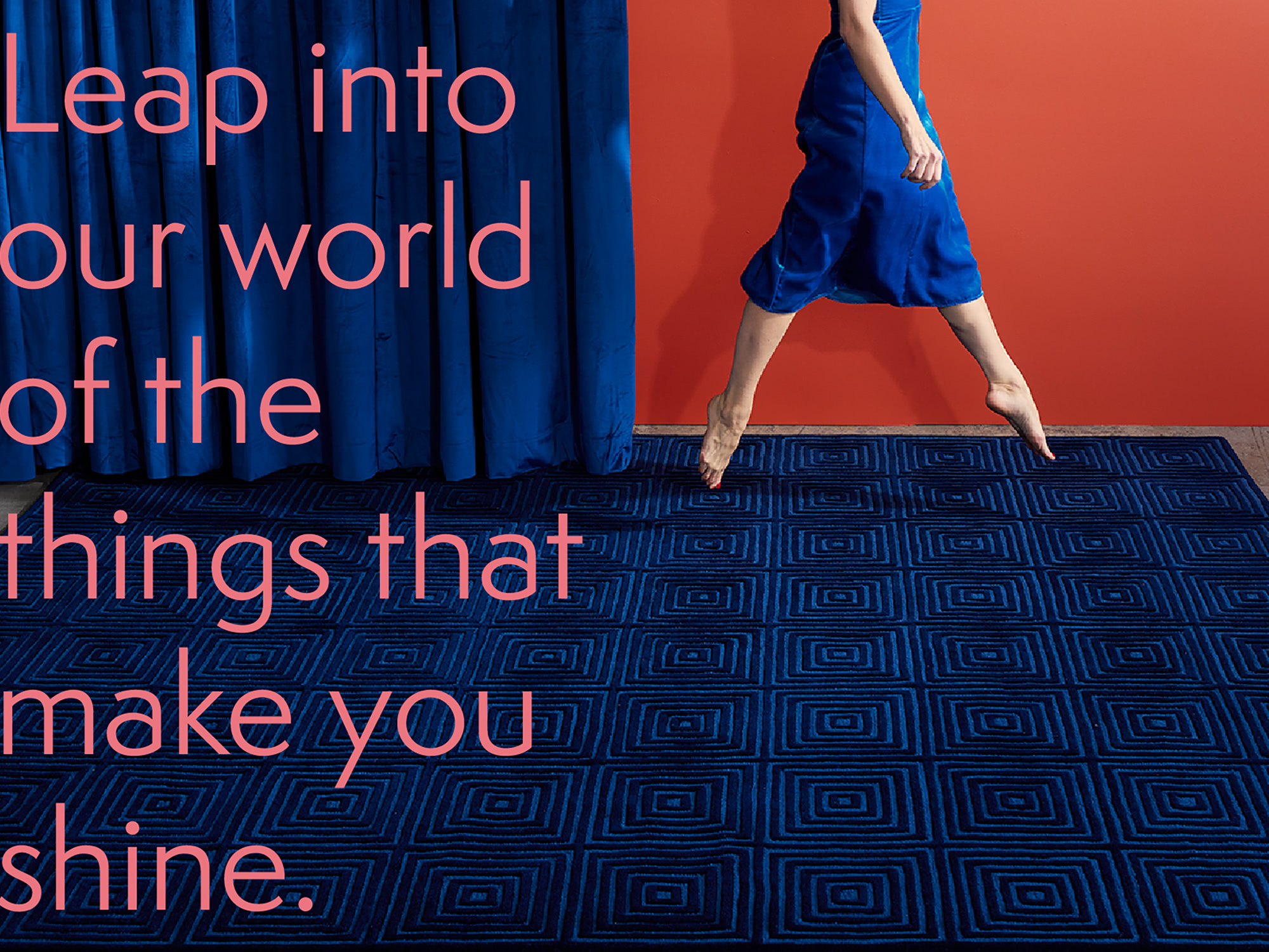 A woman in a blue dress skips across a plush blue, modern, area rug