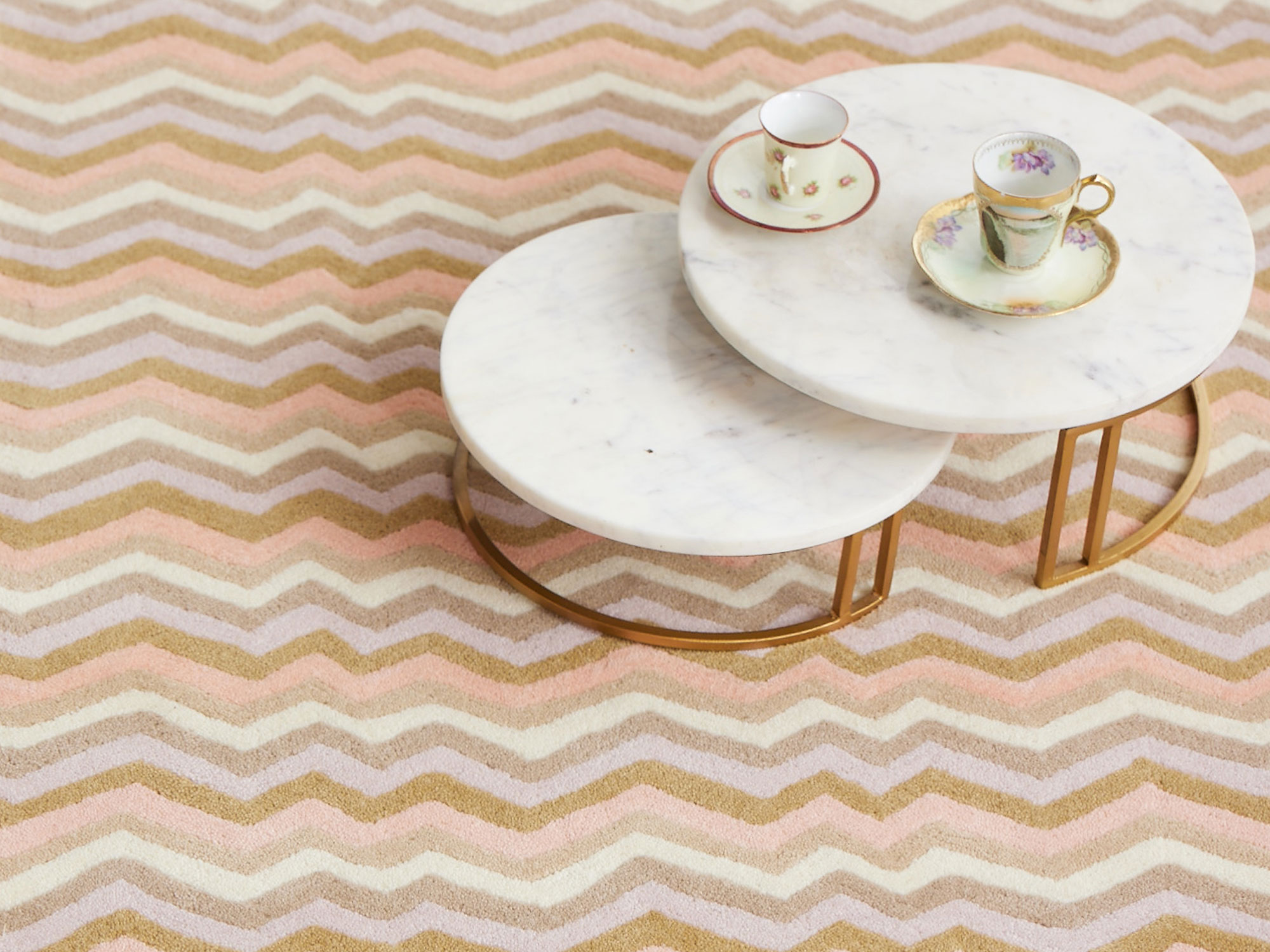 A bright, beige, pink and white area rug called Buzz Dream by Angela Adams