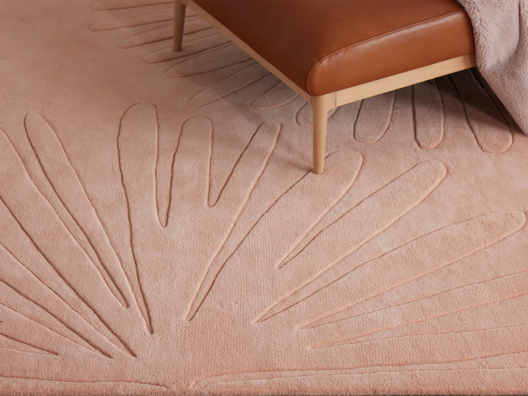 A soft pink area rug by angela adams called daisies petal
