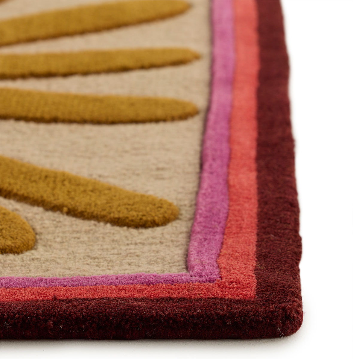 The corner detail of an abstract multi-colored rug named Urchin Uni.