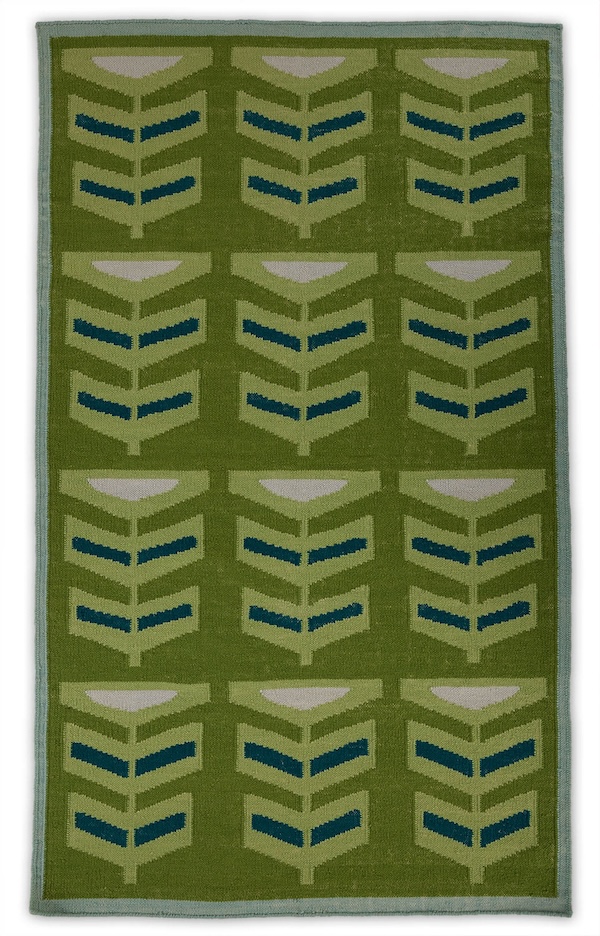 An abstract 5x8 green and blue repeating pattern on a green area rug named Pterapod Grass.