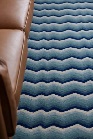 A detail of a modern area rug in blue tones called Buzz Blue