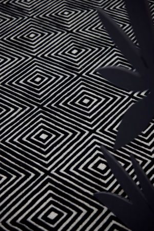 A black and white, patterned, modern area rug called Duke Vivid by Angela Adams