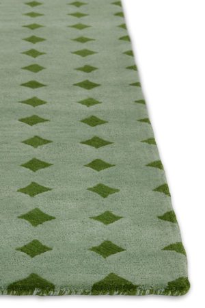A close up corner of a green area rug called Bongo Fresca