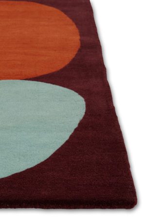A corner of a modern rug called Three Stones Rust